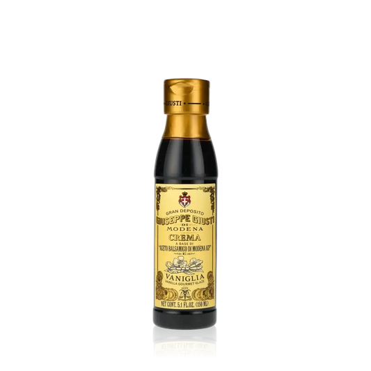 Giuseppe Giusti Crema Vanille Balsamicocreme Flasche vor schwarzem Hintergrund.
