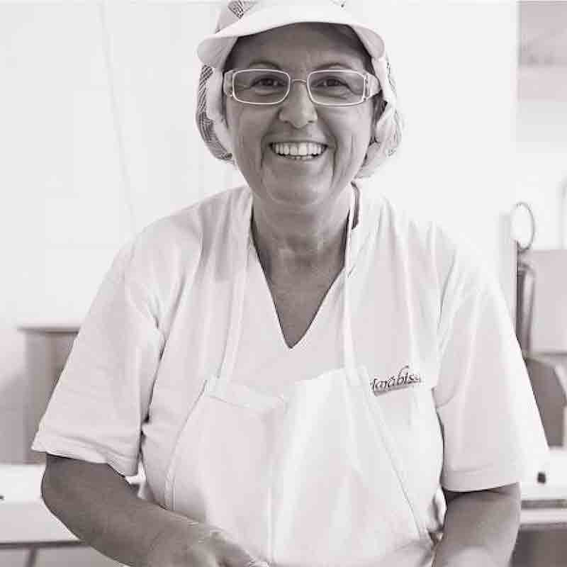 Person in Arbeitskleidung lächelt.