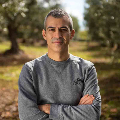 Pietro Intini. Foto des Produzenten im Olivenhain.